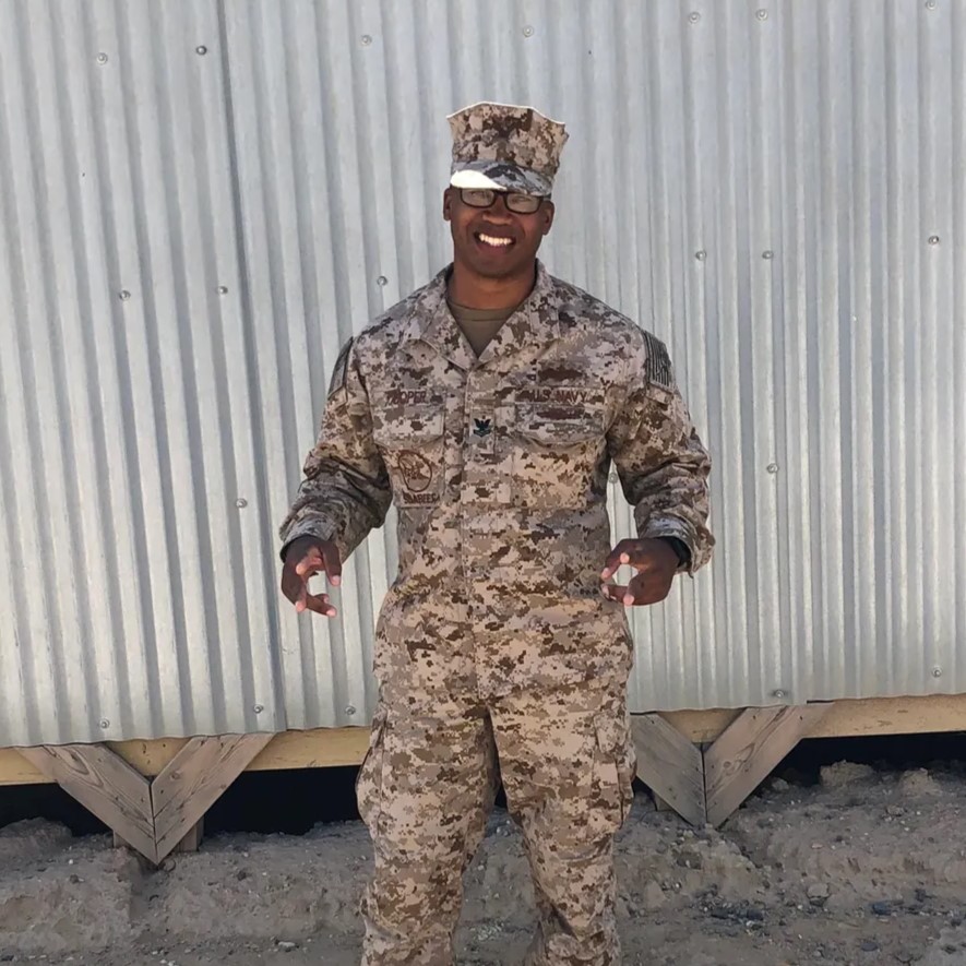 Smiling HVAC technician in a cap, inspecting an indoor air conditioning unit and checking its components